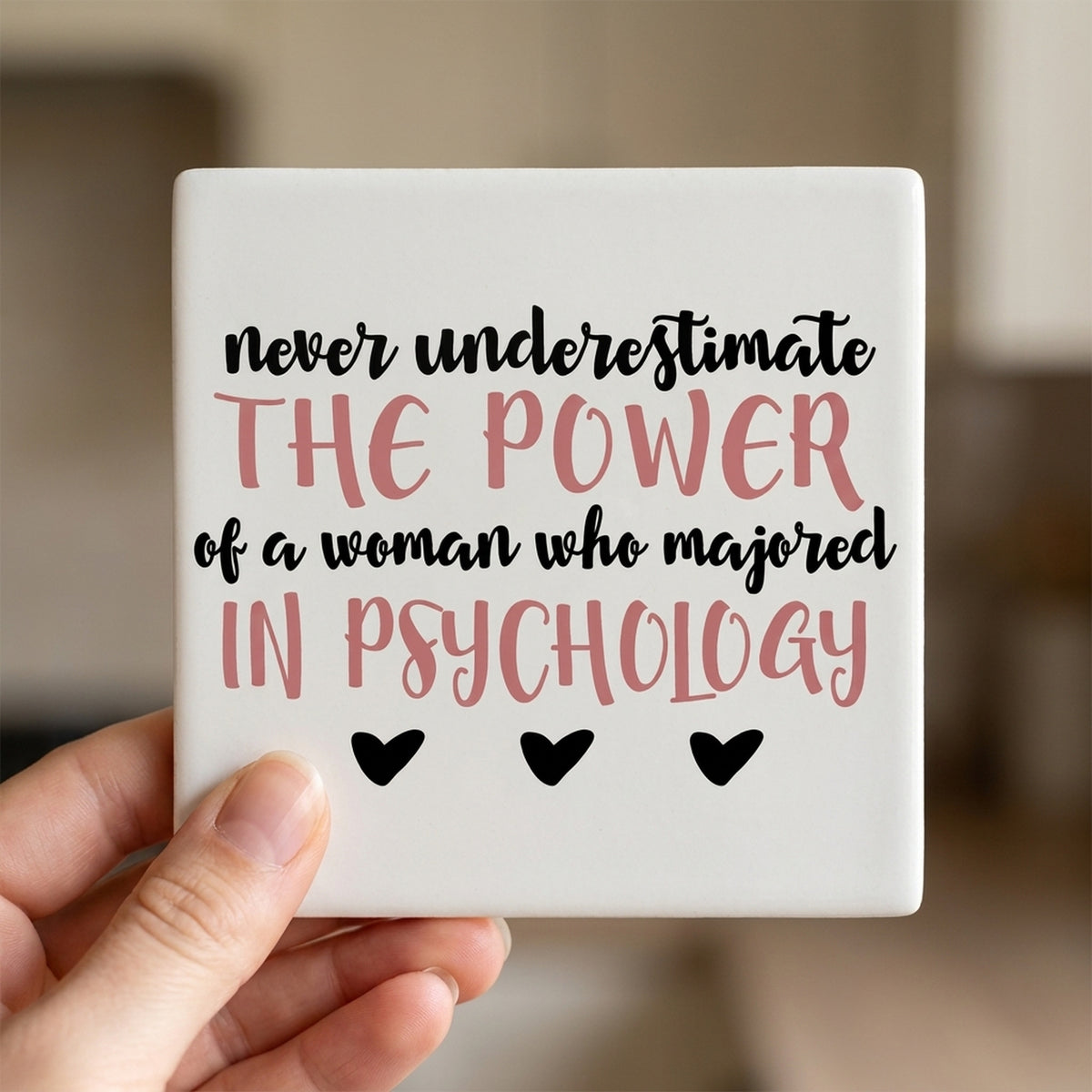 Never Underestimate Woman in Psychology ceramic coasters set of 4, in hand