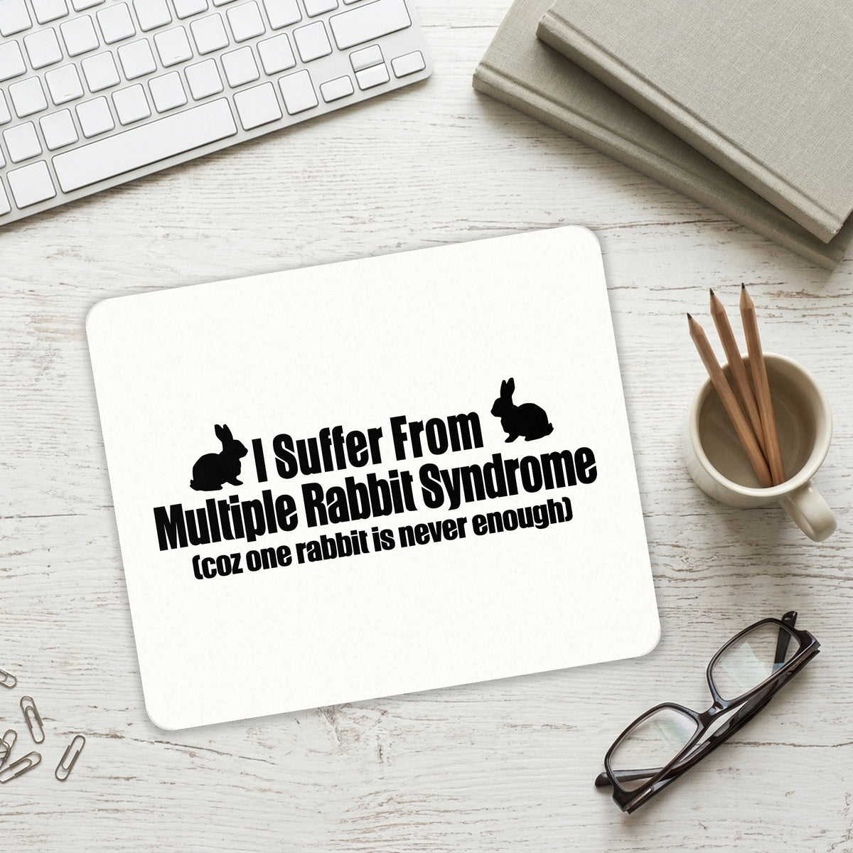 I Suffer From Multiple Rabbit Syndrome mouse pad on a desk with a keyboard