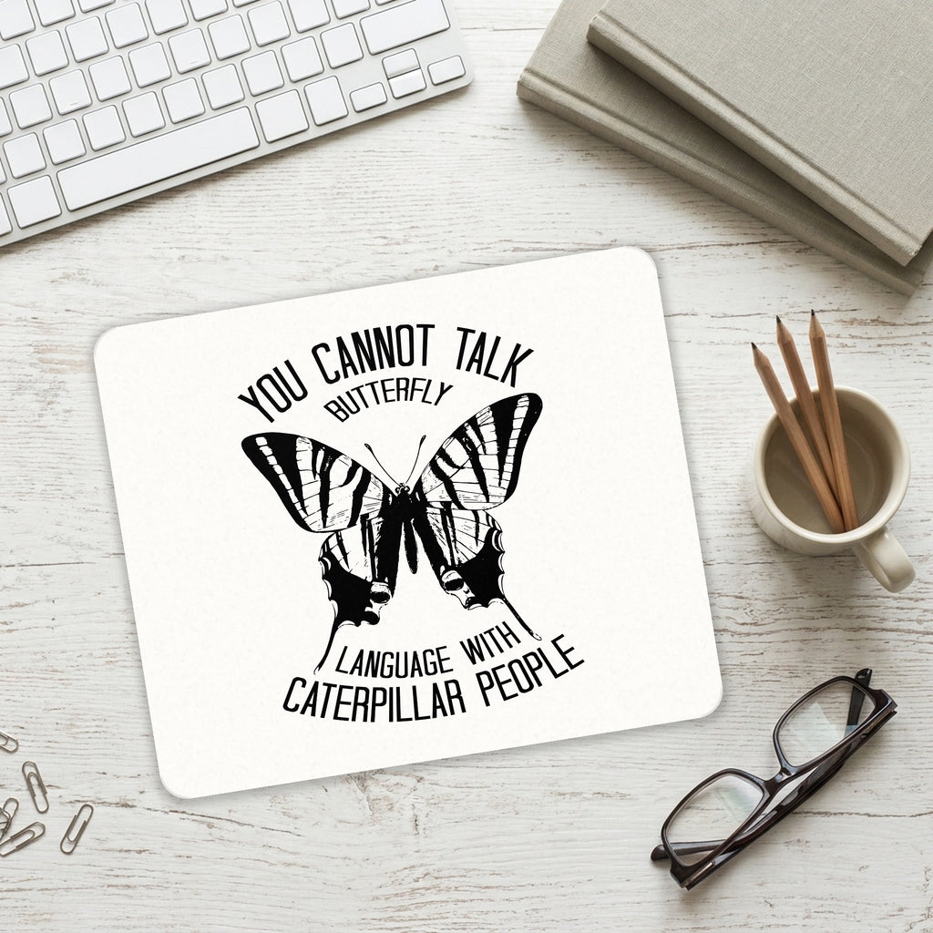 Can't Talk Butterfly with Caterpillar People mouse pad on a desk with a keyboard