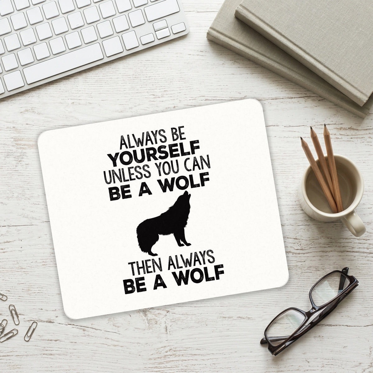 Always Be Yourself Unless You Can Be a Wolf mouse pad on a desk with a keyboard