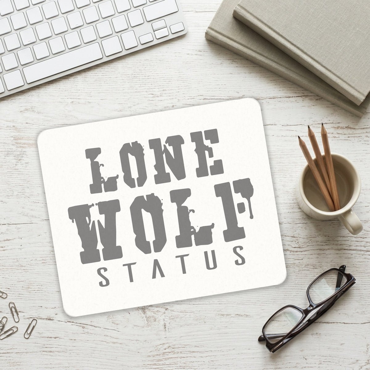 Lone Wolf Status mouse pad on a desk with a keyboard