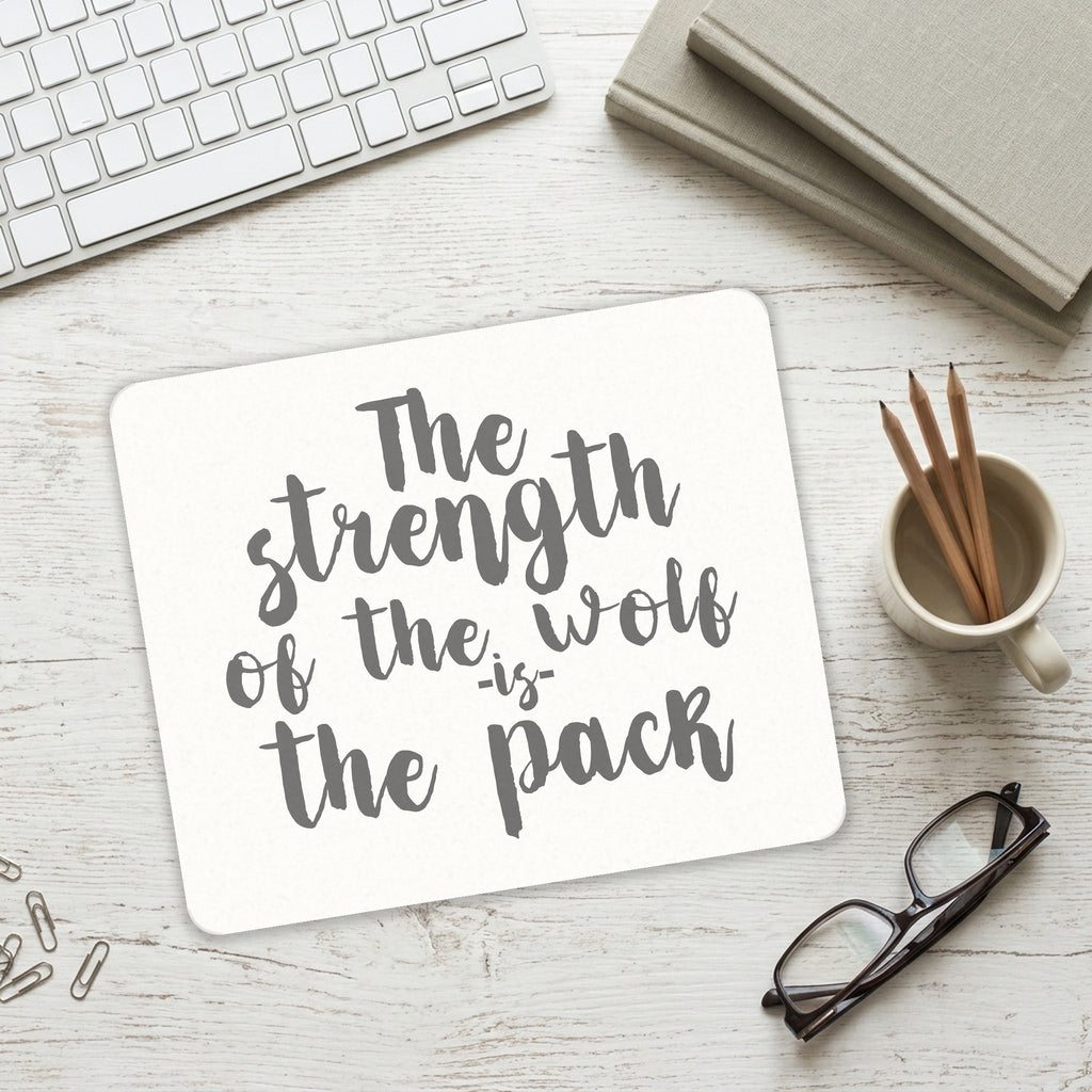 Strength of the Wofl is the Pack mouse pad on a desk with a keyboard