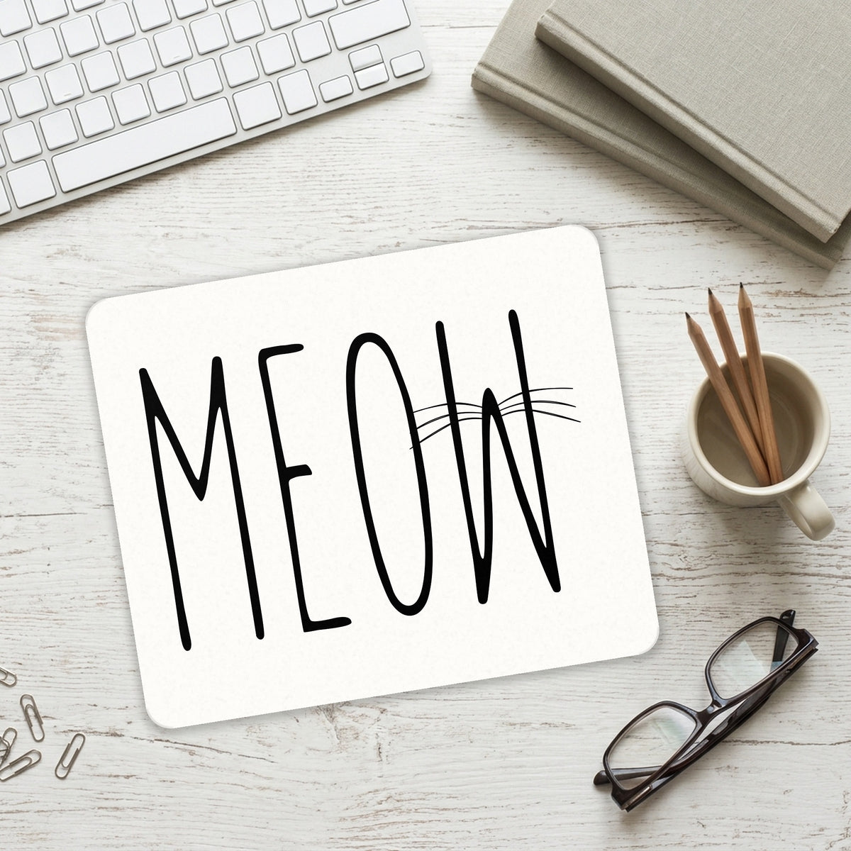 Meow - Cat Whiskers mouse pad on a desk with a keyboard