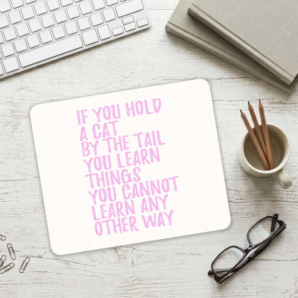 Hold a Cat by the Tail, Learn Things mouse pad on a desk with a keyboard