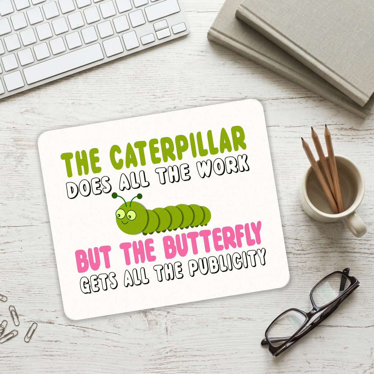 Caterpillar Does Work, Butterfly Publicity mouse pad on a desk with a keyboard