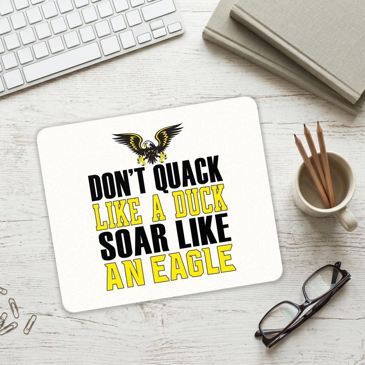 Don't Quack Like Duck, Soar Like Eagle mouse pad on a desk with a keyboard