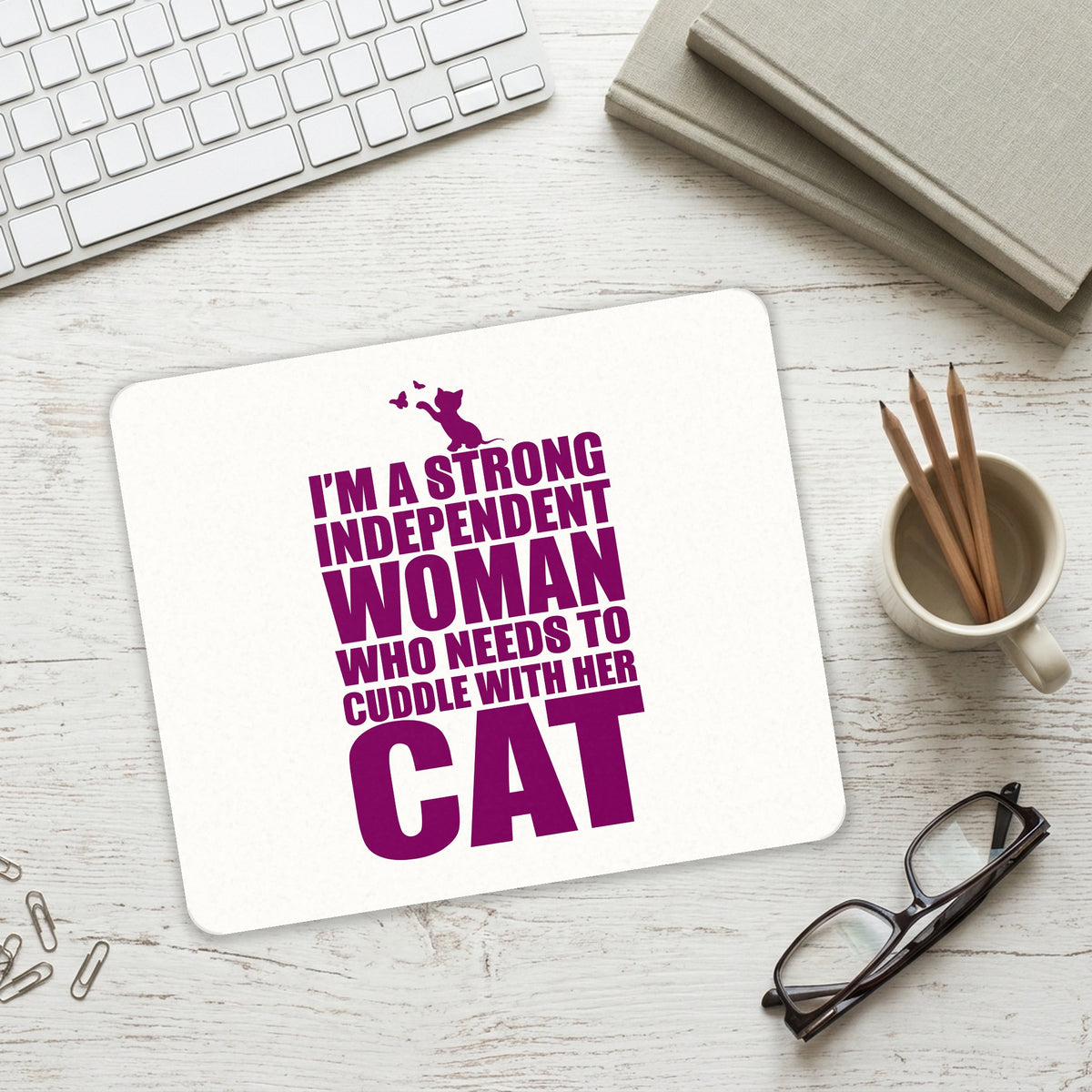 Strong Woman Needs to Cuddle Cat mouse pad on a desk with a keyboard