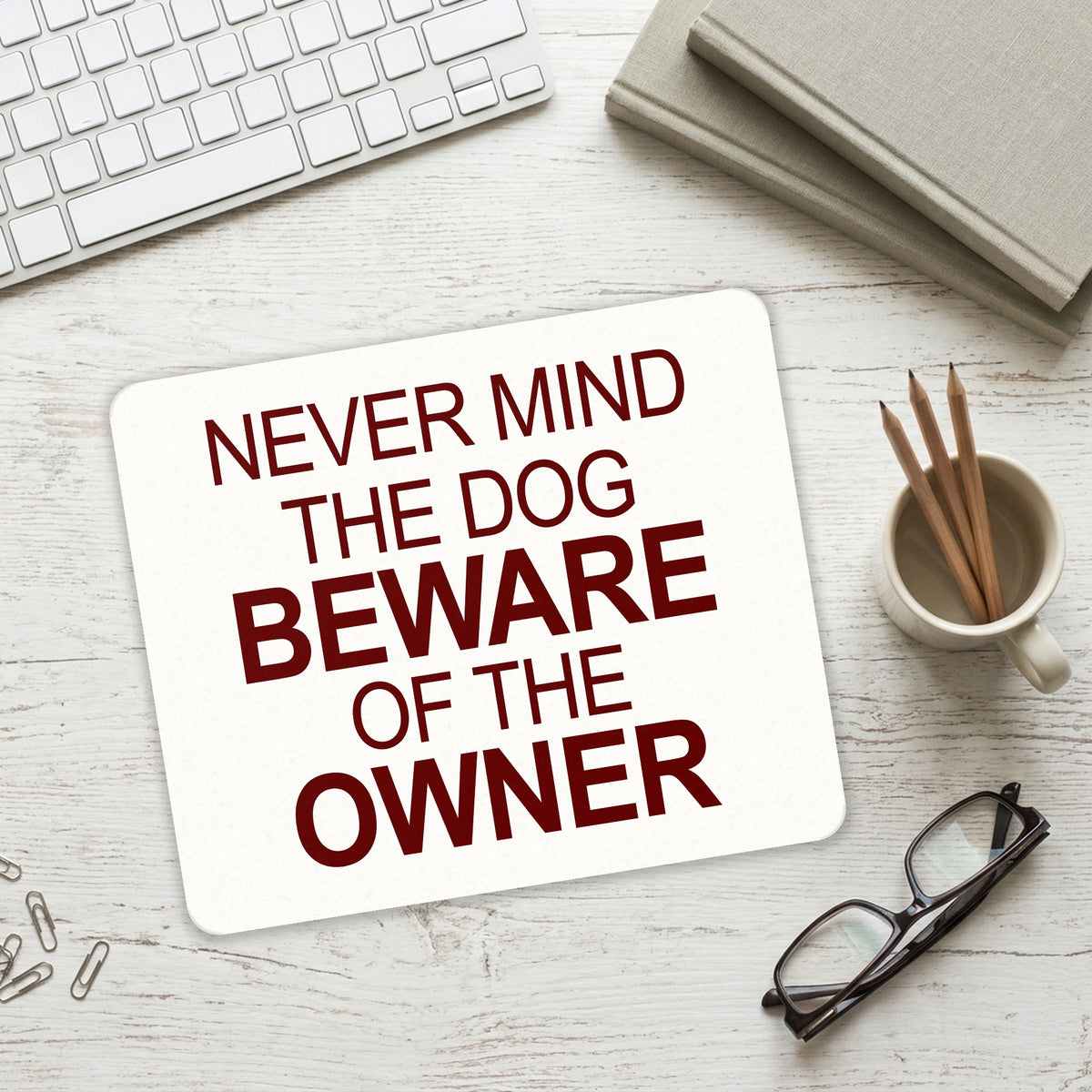 Never Mind the Dog, Beware the Owner mouse pad on a desk with a keyboard