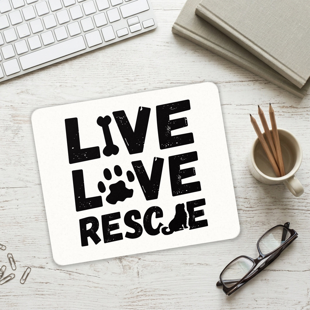 Live Love Rescue - Dog Paw mouse pad on a desk with a keyboard