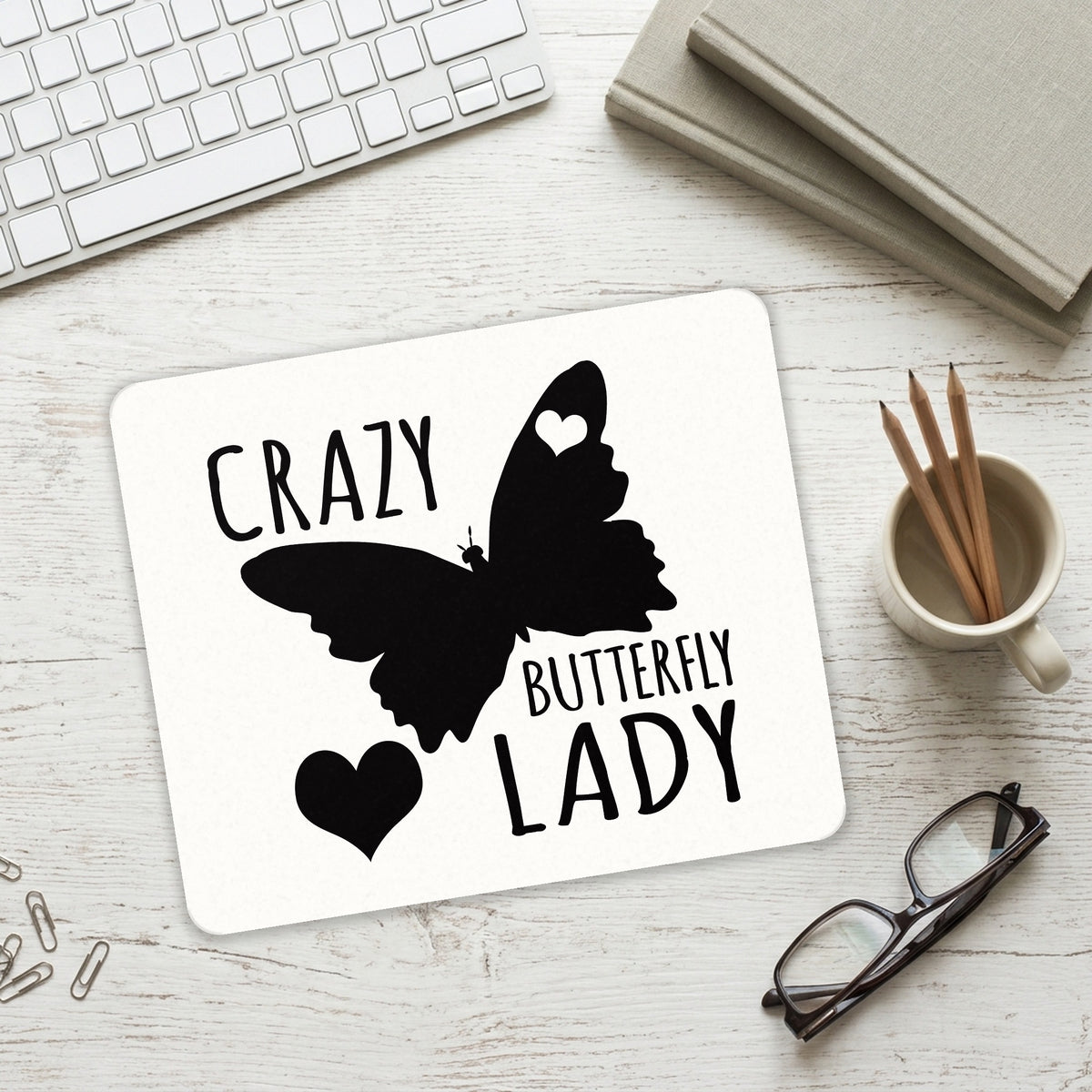Crazy Butterfly Lady mouse pad on a desk with a keyboard