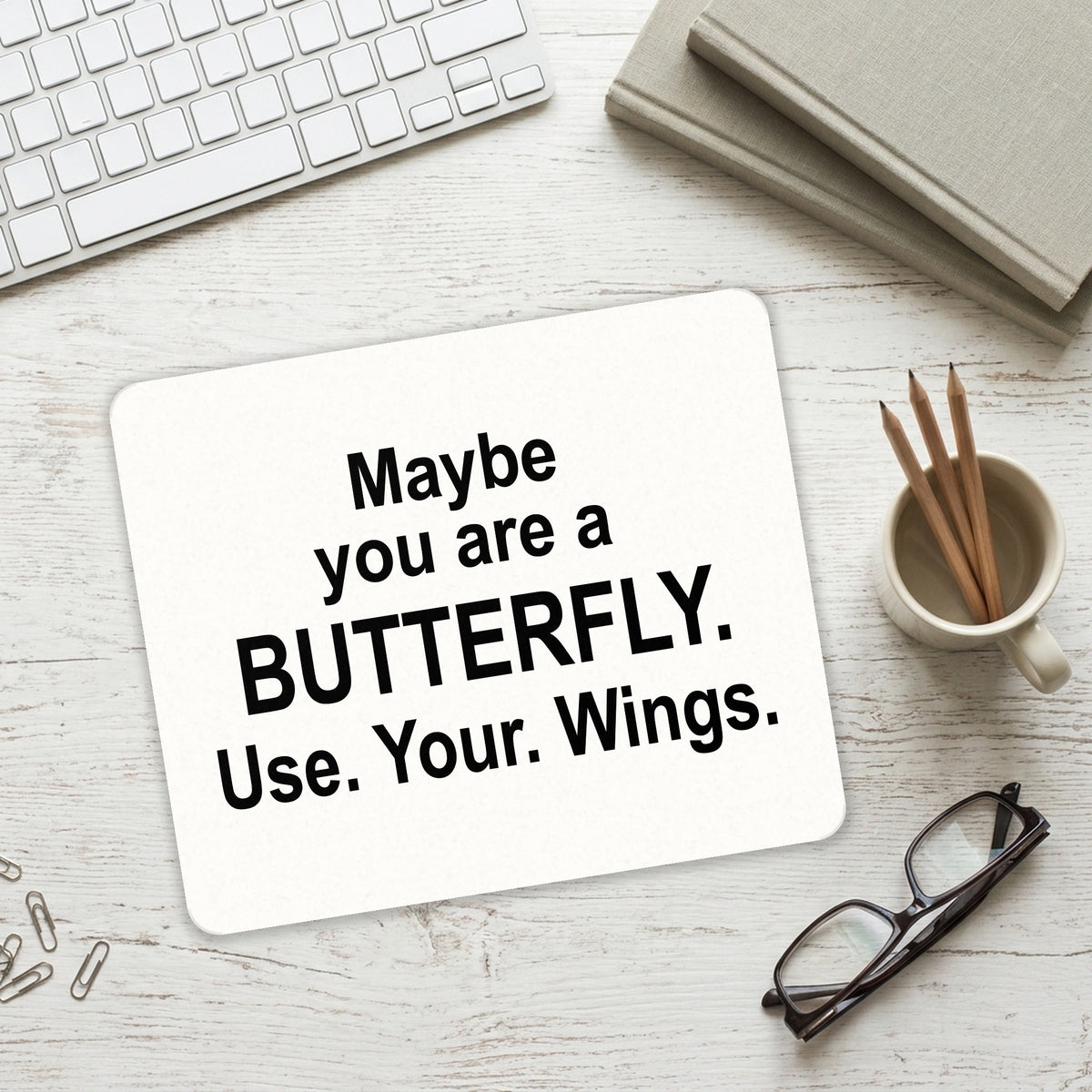 Maybe You Are a Butterfly mouse pad on a desk with a keyboard
