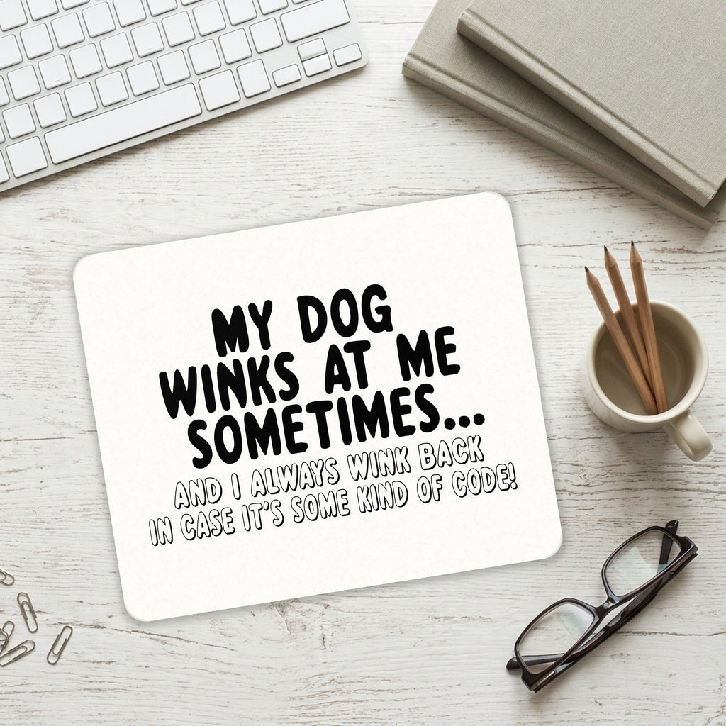 My Dog Winks at Me Sometimes mouse pad on a desk with a keyboard