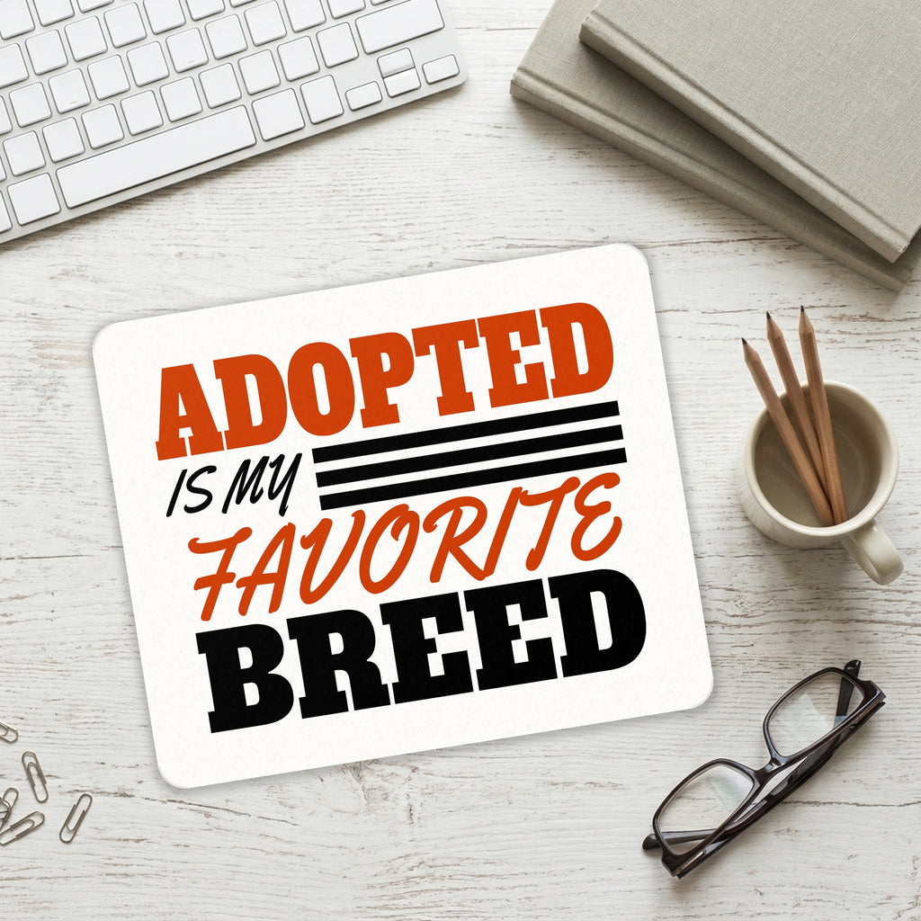 Adopted is My Favorite Breed mouse pad on a desk with a keyboard