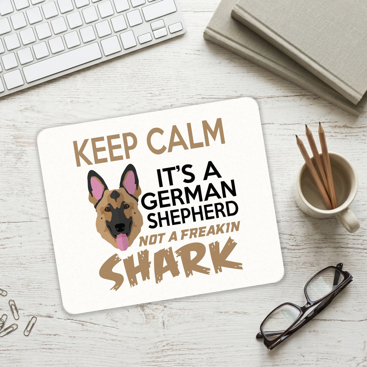 Keep Calm - It's a German Shepherd mouse pad on a desk with a keyboard