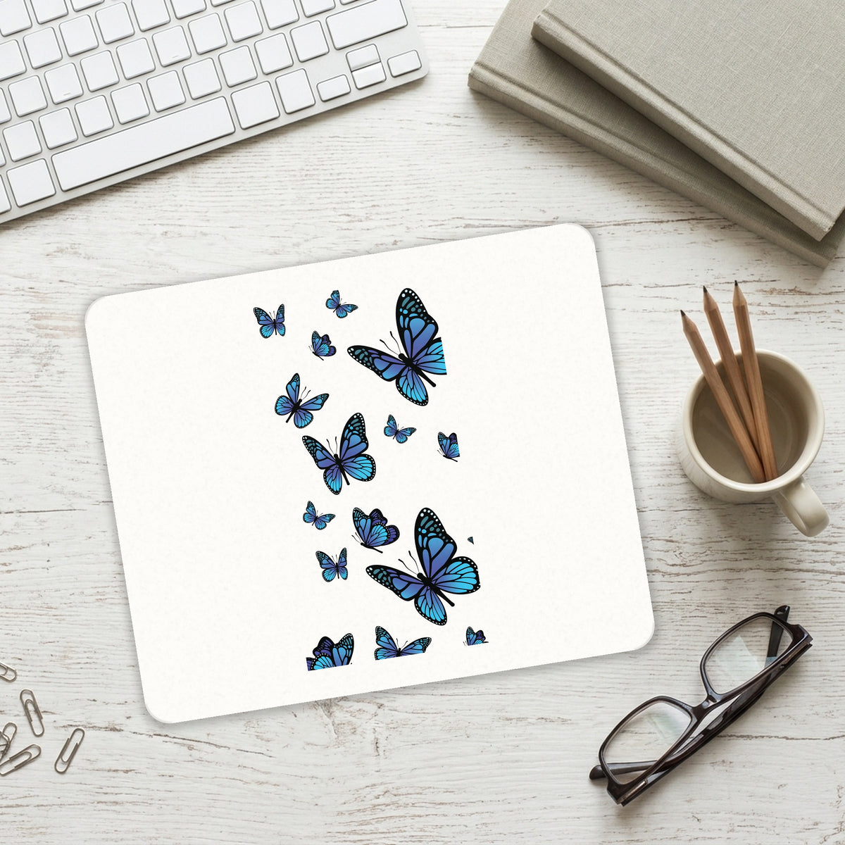 Blue Butterflies Butterfly mouse pad on a desk with a keyboard