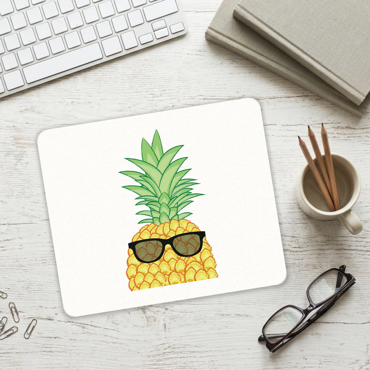 Pineapple Top with Shades mouse pad on a desk with a keyboard