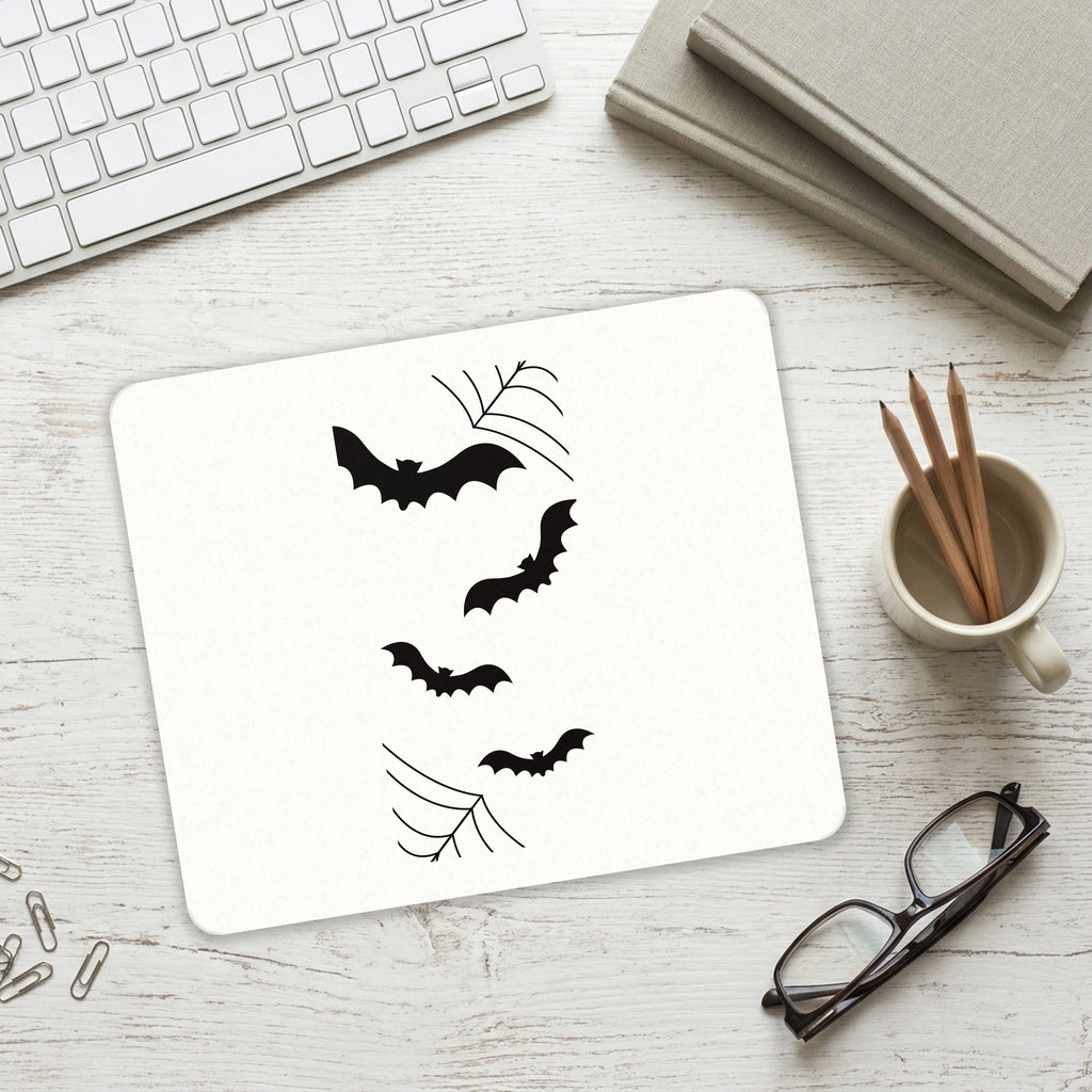 Bats and Spider Webs mouse pad on a desk with a keyboard