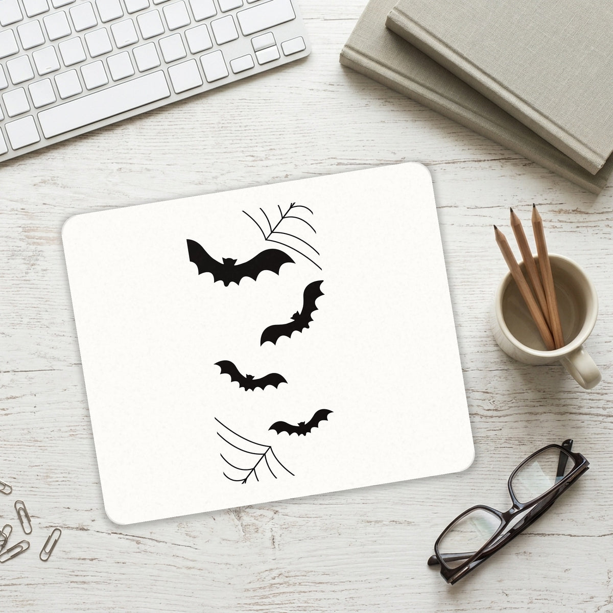 Bats and Spider Webs mouse pad on a desk with a keyboard
