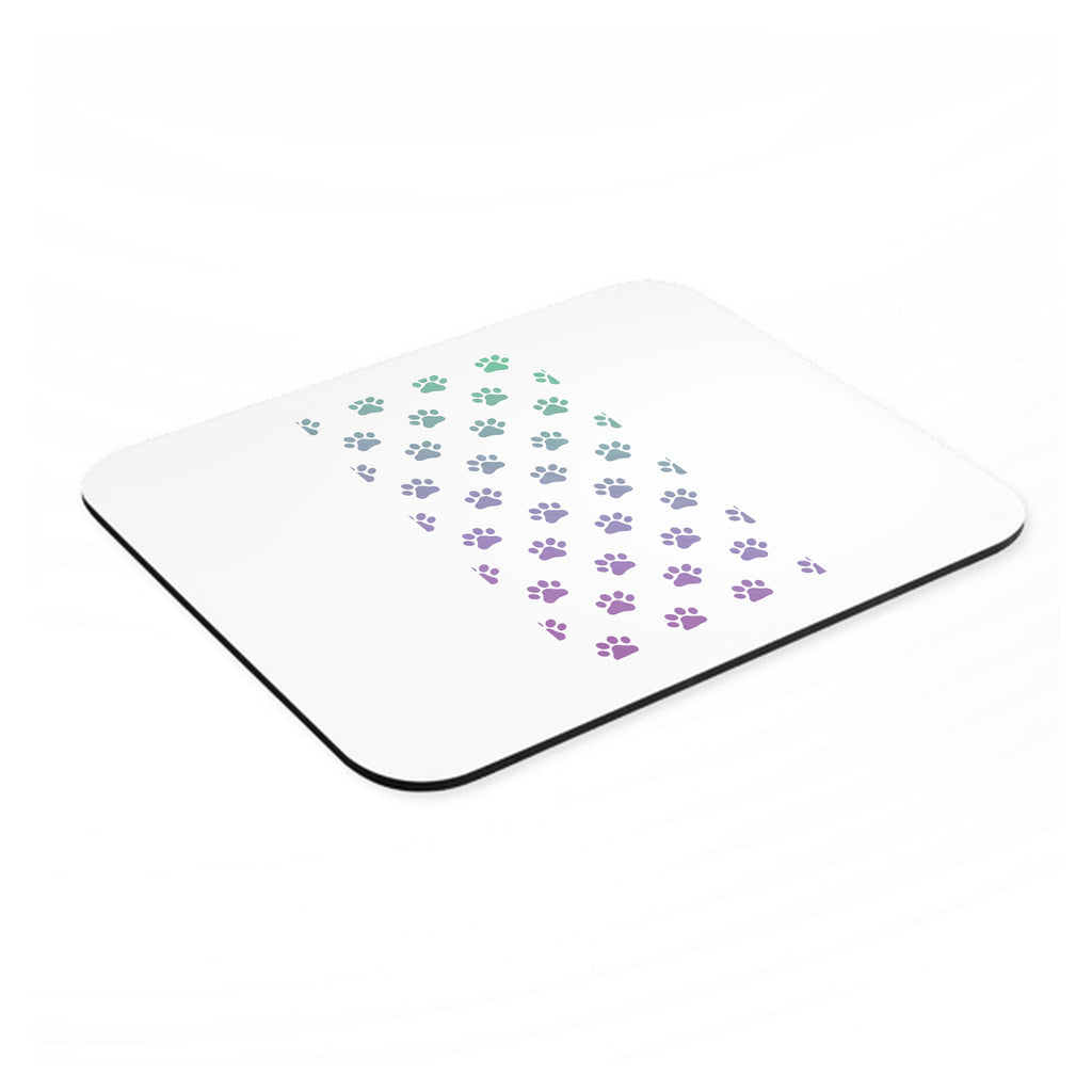 Gradient Pawprints - Purple to Green mouse pad, angled view showing the 1/4 inch thick base