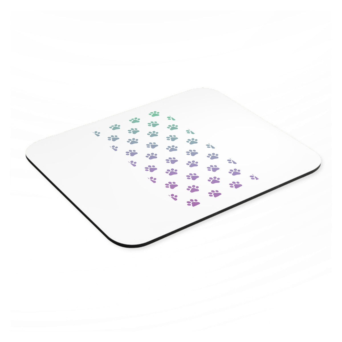 Gradient Pawprints - Purple to Green mouse pad, angled view showing the 1/4 inch thick base