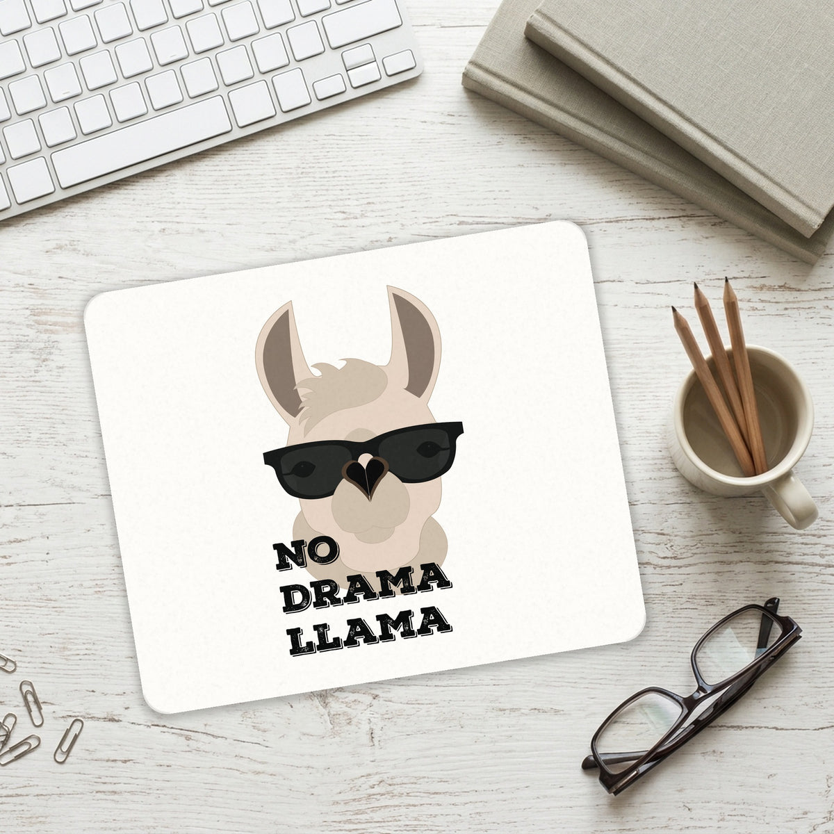 No Drama Llama Cartoon mouse pad on a desk with a keyboard
