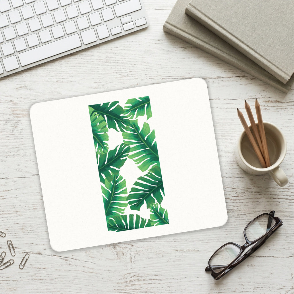 Tropical Banana Leaves mouse pad on a desk with a keyboard