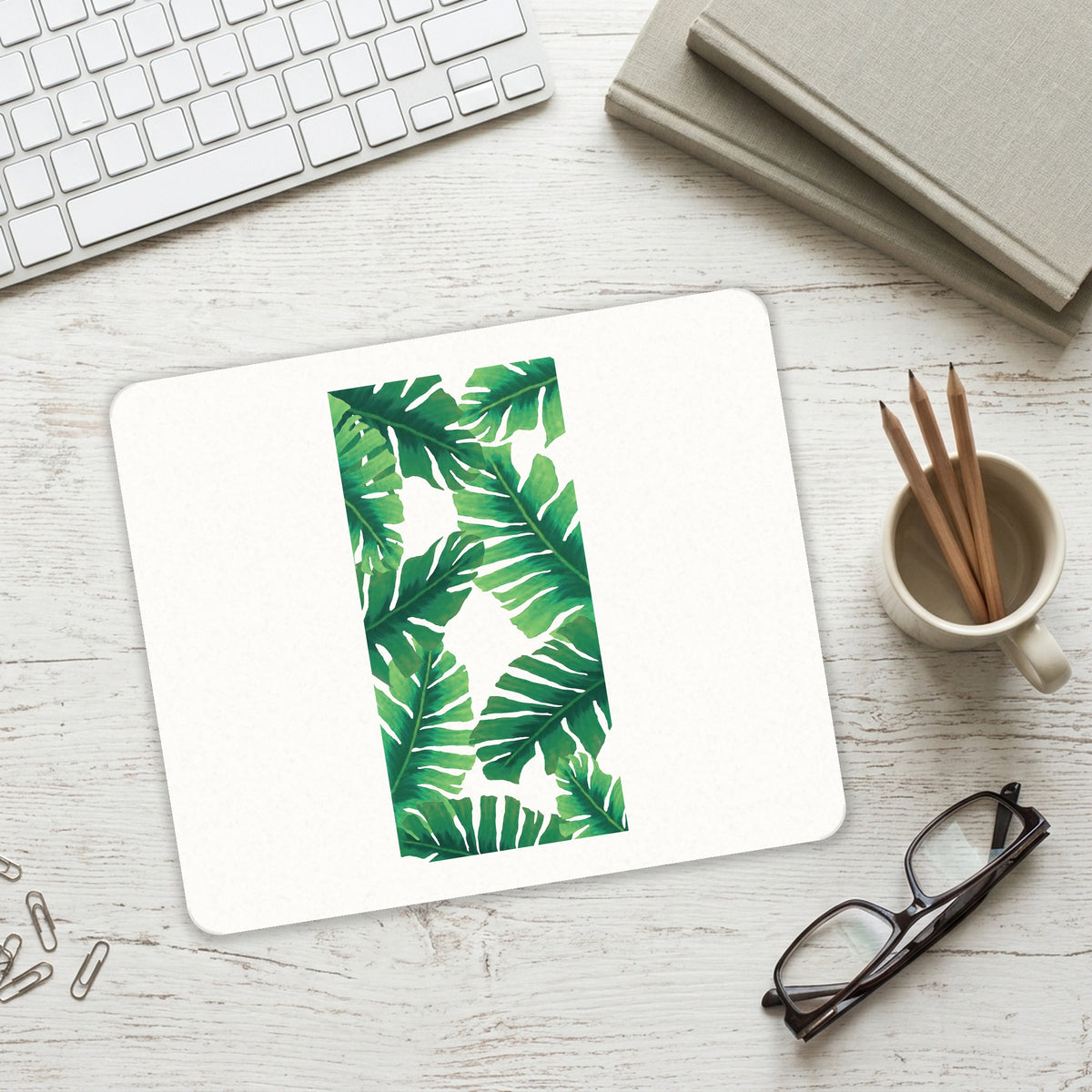 Tropical Banana Leaves mouse pad on a desk with a keyboard