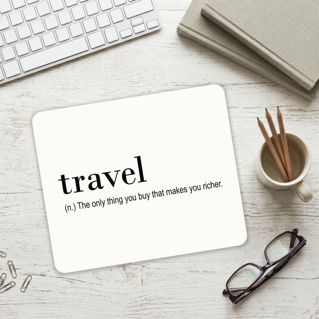 Travel - Thing to buy that makes you richer mouse pad on a desk with a keyboard