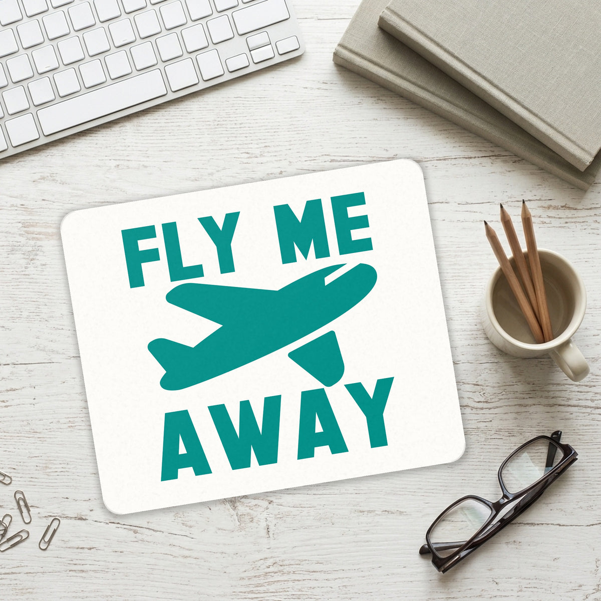 Fly Me Away - Travel mouse pad on a desk with a keyboard