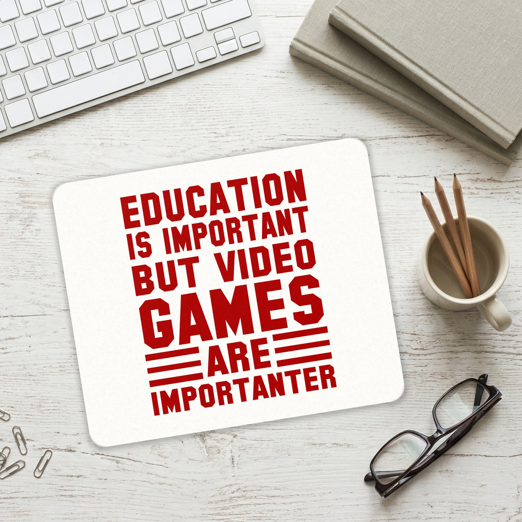 Education is Important Video Games Importanter mouse pad on a desk with a keyboard