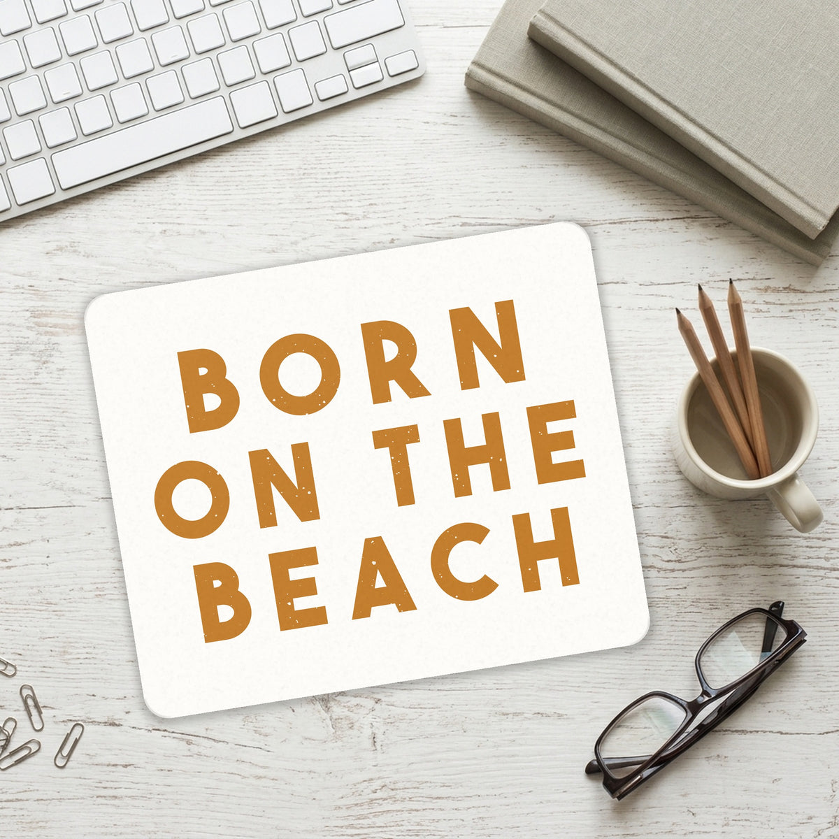 Born on the Beach mouse pad on a desk with a keyboard