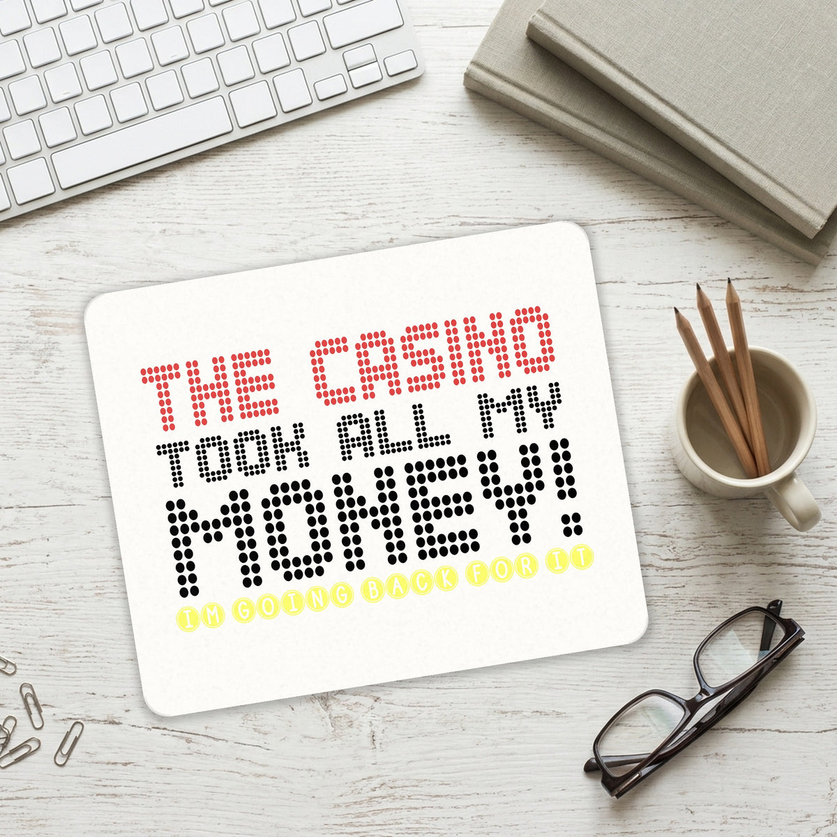 The Casino Took All My Money mouse pad on a desk with a keyboard