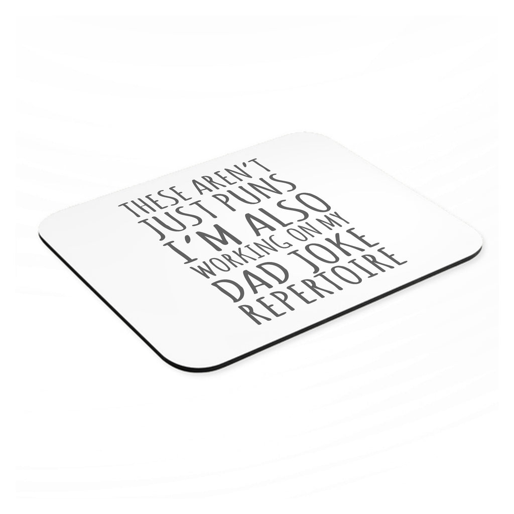Not Just Puns I'm Also Working Dad Joke mouse pad, angled view showing the 1/4 inch thick base
