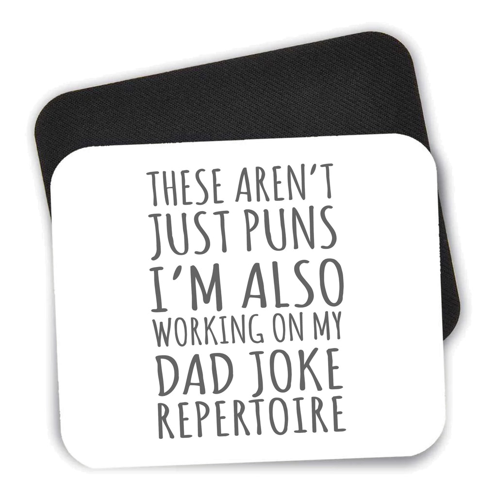Not Just Puns I'm Also Working Dad Joke mouse pad shown with its black non-slip rubber underside