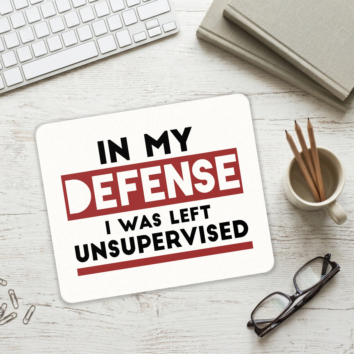 In My Defense, I Was Left Unsupervised mouse pad on a desk with a keyboard