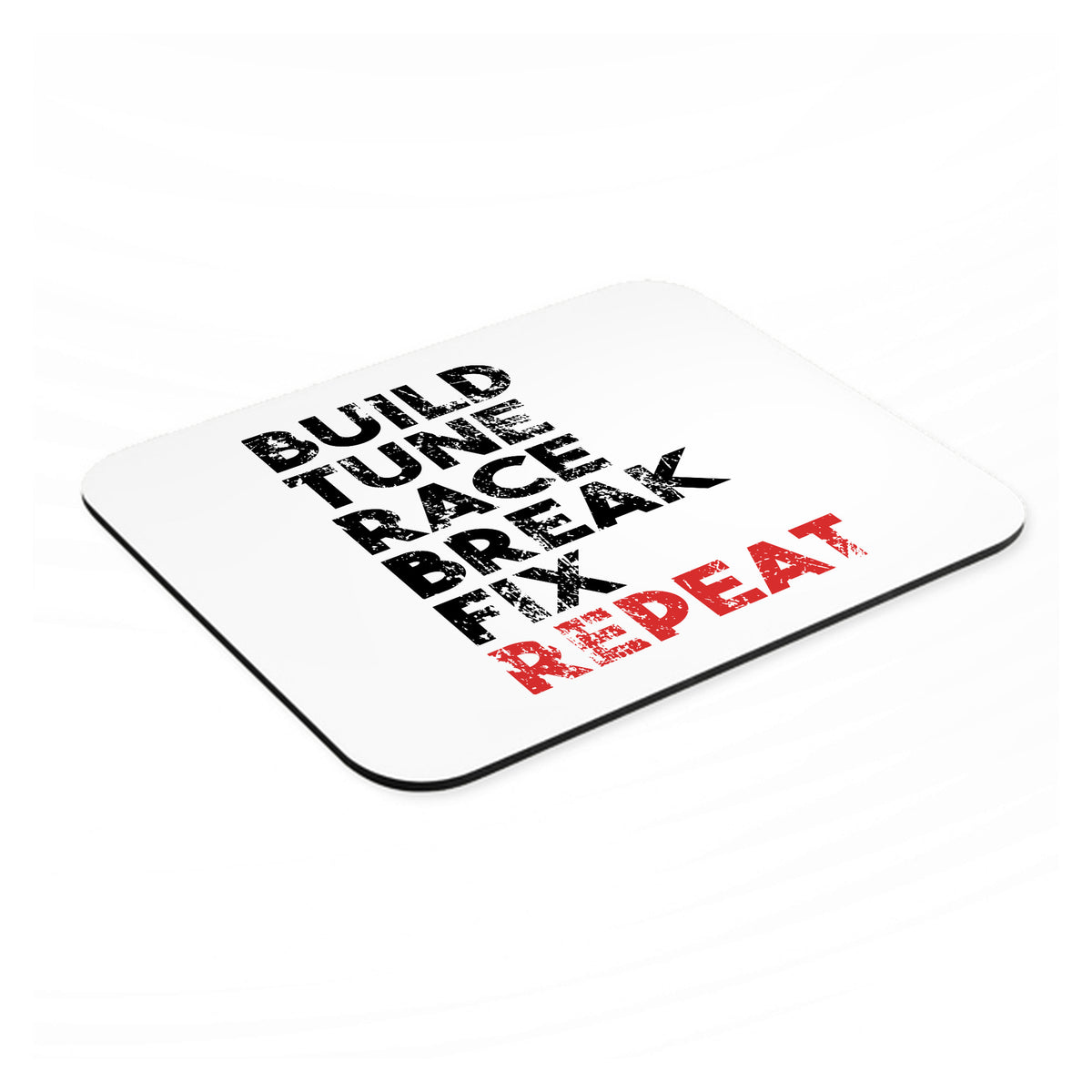 Build Tune Race Break Fix Repeat mouse pad, angled view showing the 1/4 inch thick base