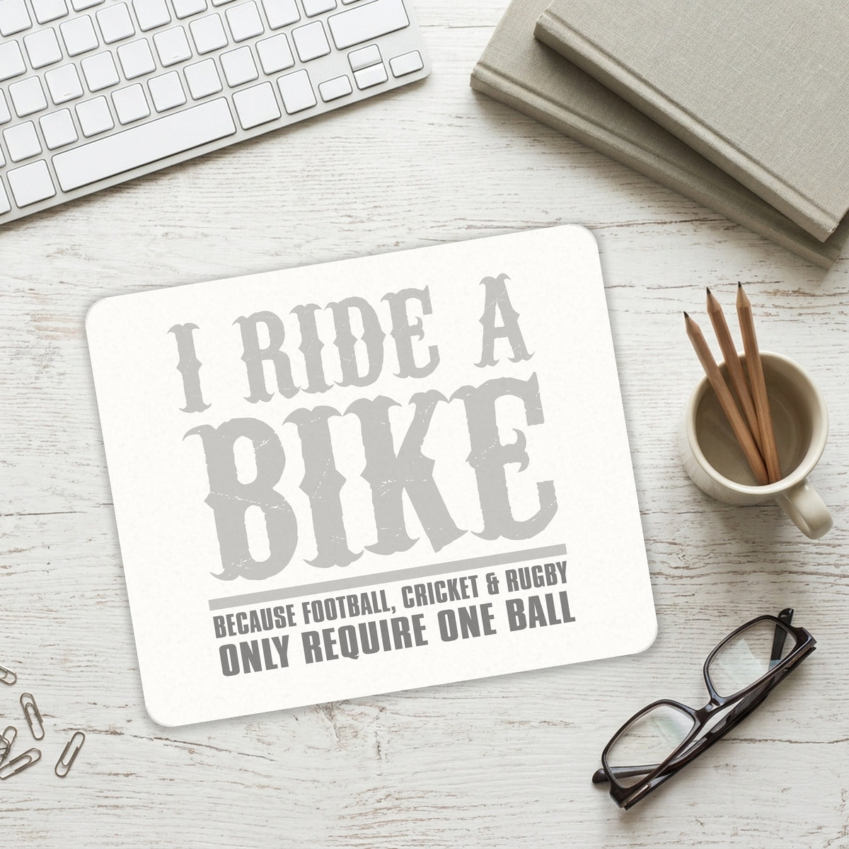 I Ride Bike - Sports Only Require 1 Ball mouse pad on a desk with a keyboard