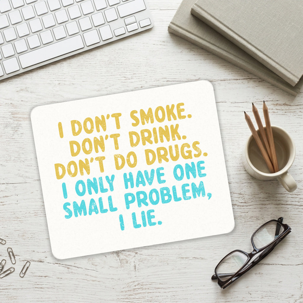 I Don't Smoke, Drink, Drugs - I Lie mouse pad on a desk with a keyboard