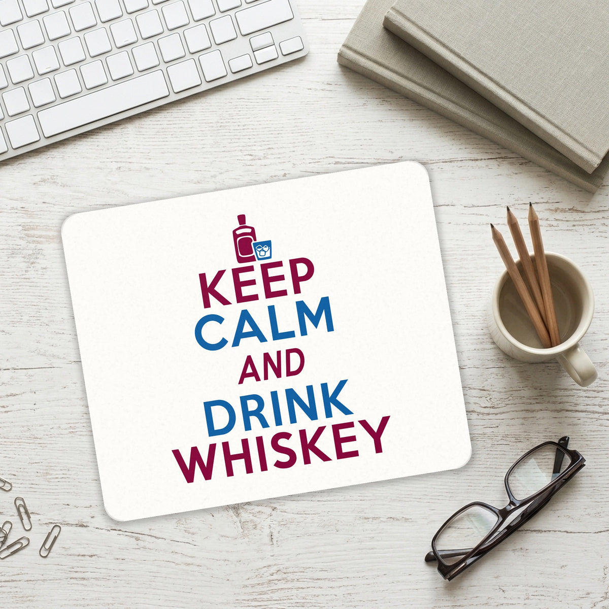 Keep Calm and Drink Whiskey mouse pad on a desk with a keyboard