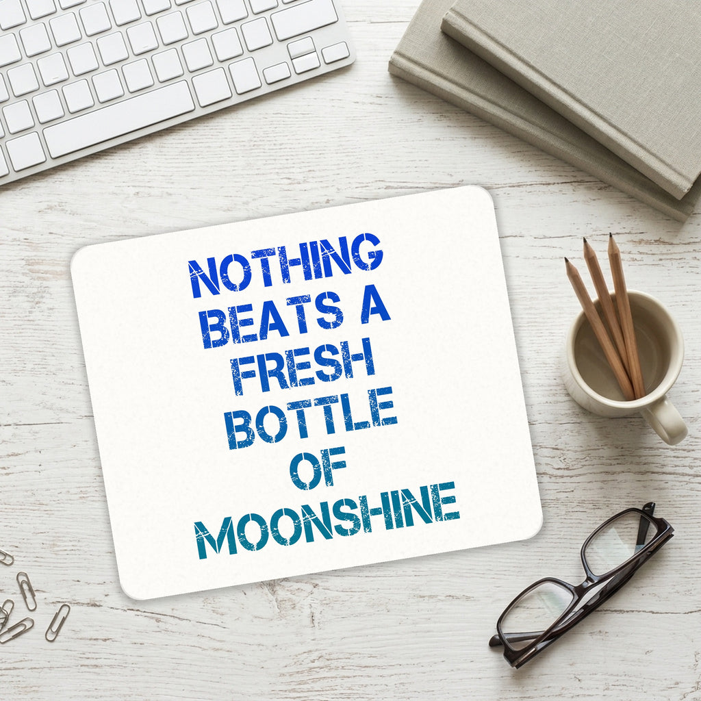 Nothing Beats a Fresh Bottle of Moonshine mouse pad on a desk with a keyboard
