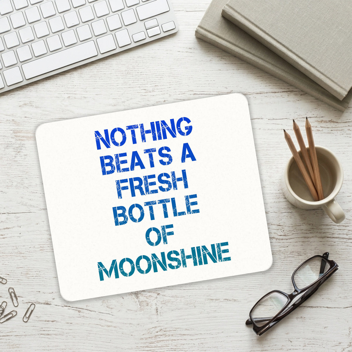 Nothing Beats a Fresh Bottle of Moonshine mouse pad on a desk with a keyboard