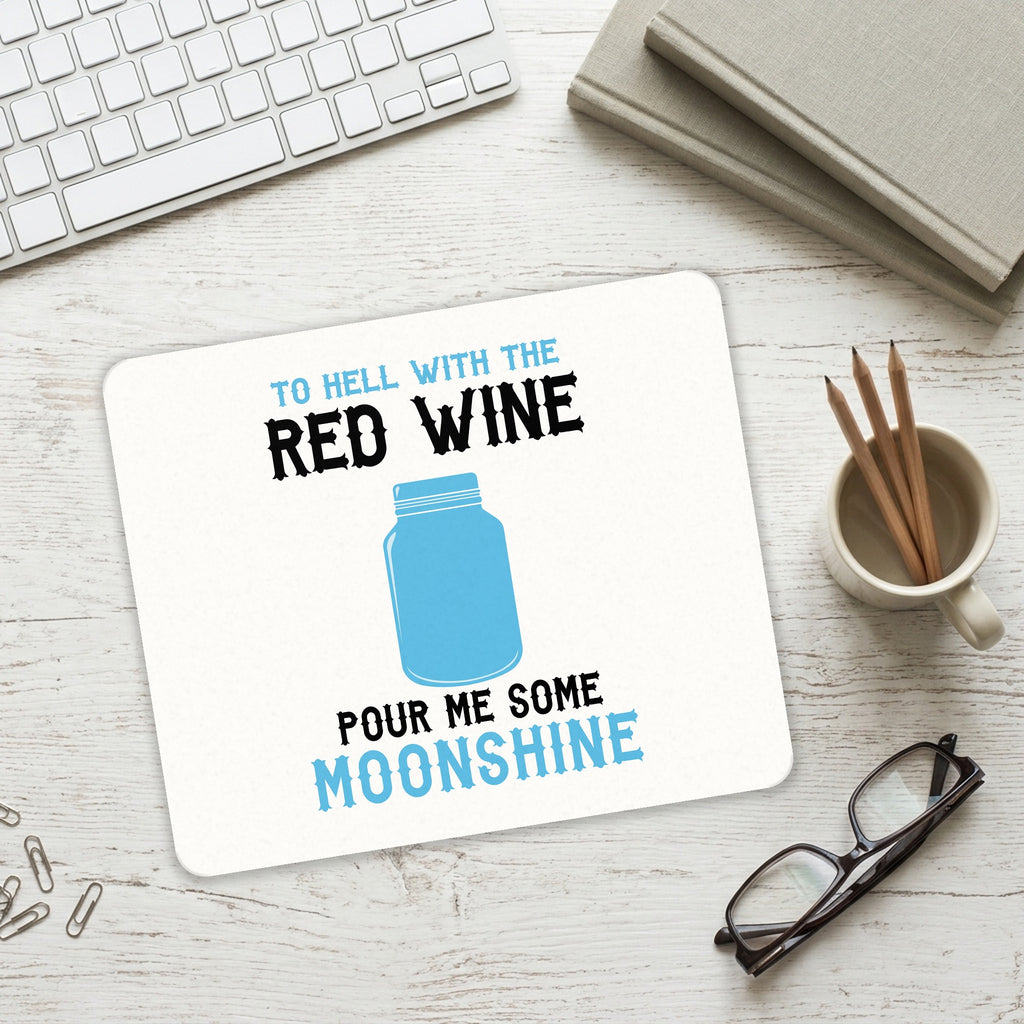 To Hell with Red Wine Pour Me Moonshine mouse pad on a desk with a keyboard