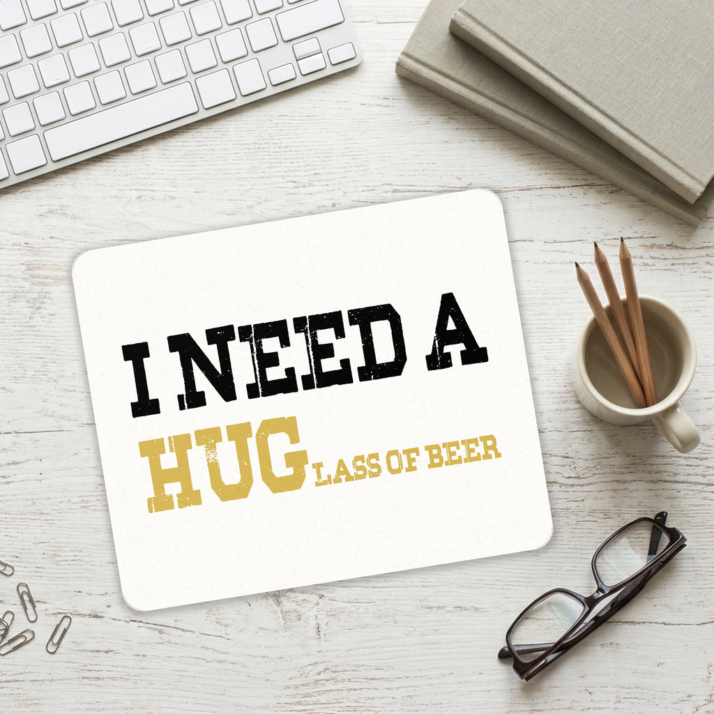 I Need a HUGlass of Beer mouse pad on a desk with a keyboard