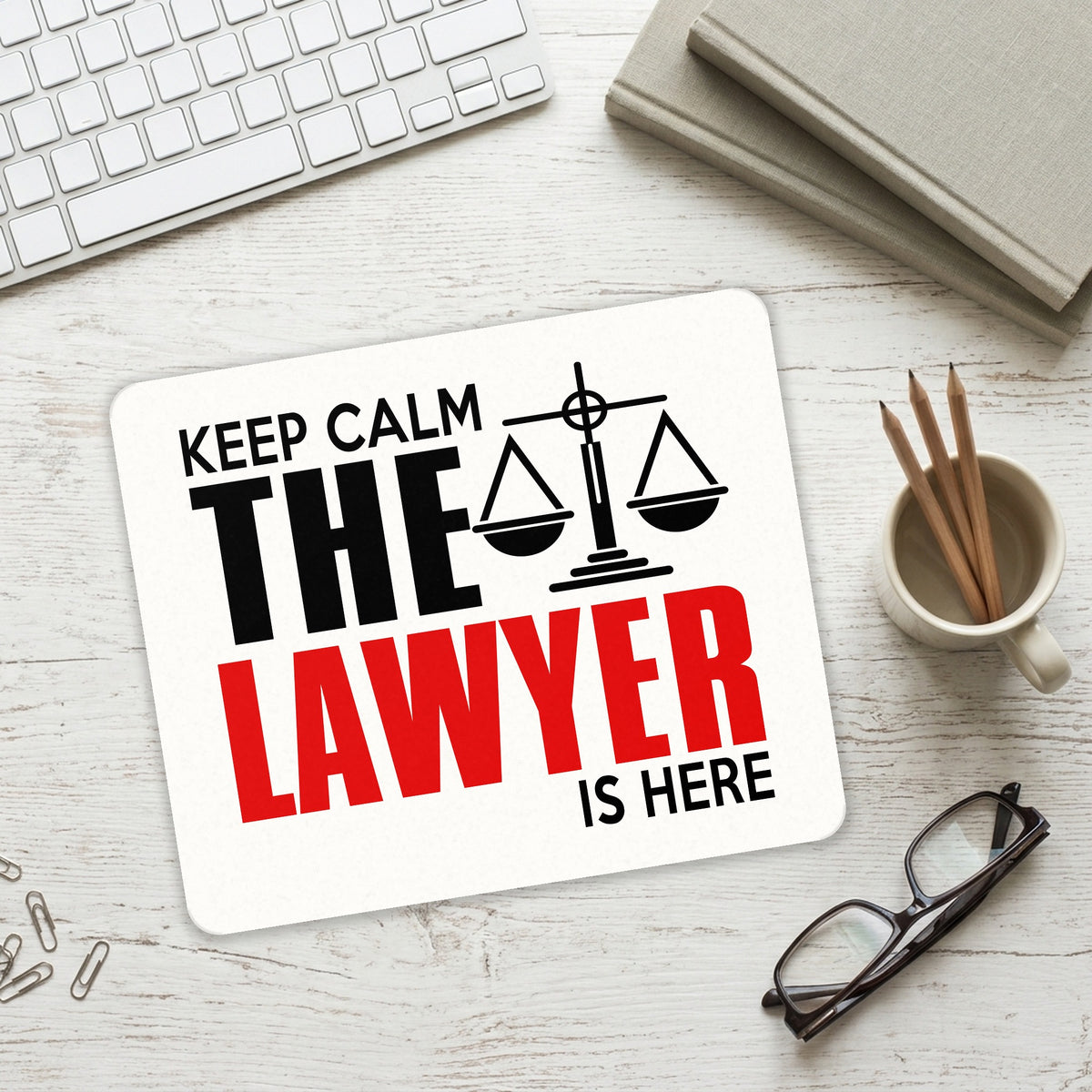 Keep Calm The Lawyer Is Here mouse pad on a desk with a keyboard