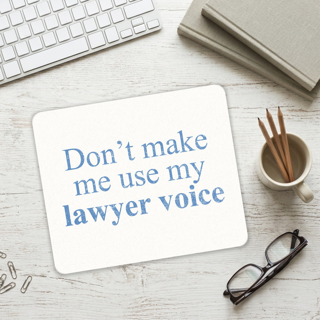 Don't Make Me Use My Lawyer Voice mouse pad on a desk with a keyboard
