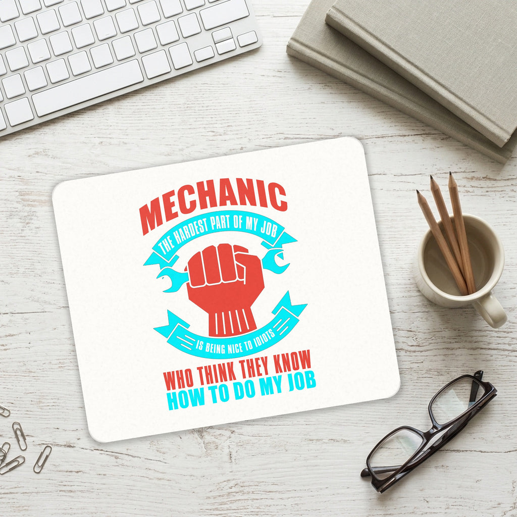 Mechanic Being Nice to Idiots mouse pad on a desk with a keyboard