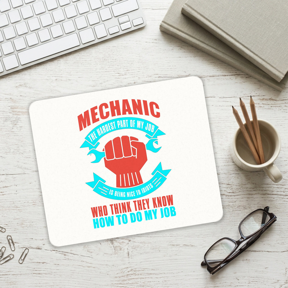 Mechanic Being Nice to Idiots mouse pad on a desk with a keyboard
