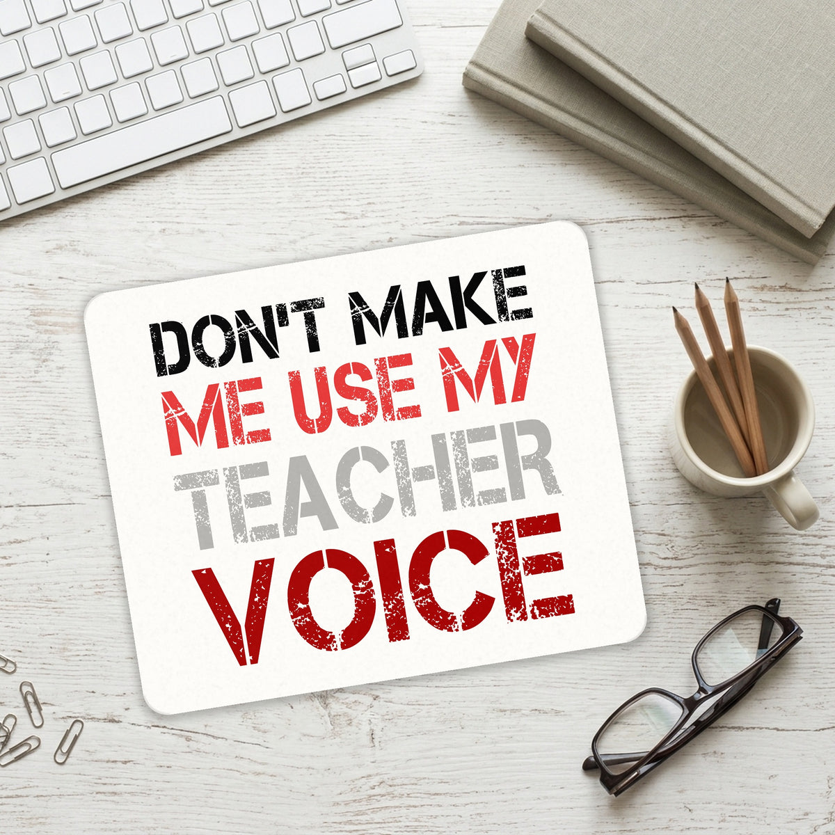 Don't Make Me Use My Teacher Voice mouse pad on a desk with a keyboard
