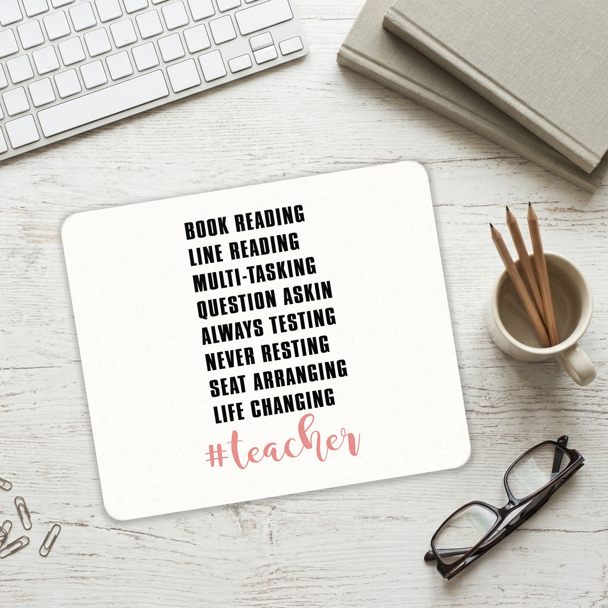 Teacher Book Reading Line Multi Tasking mouse pad on a desk with a keyboard