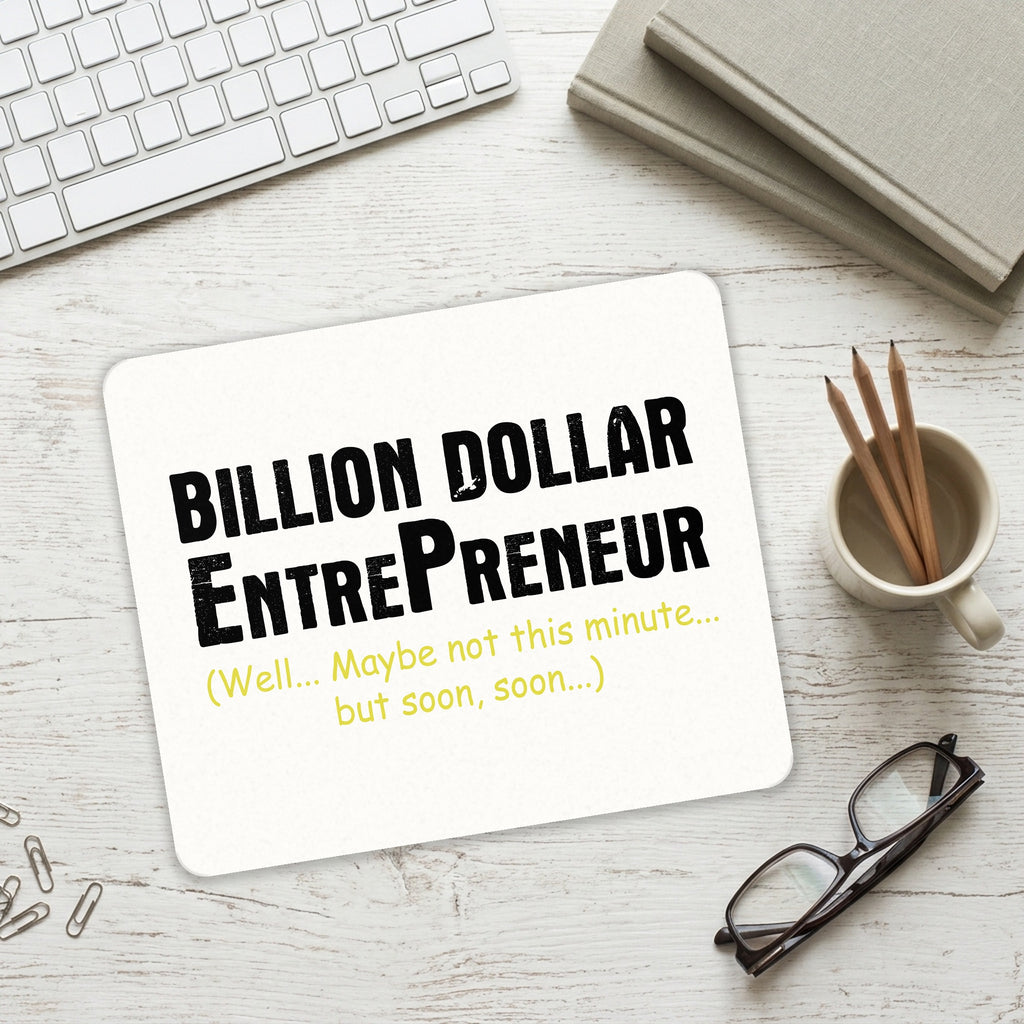 Billion Dollar Entrepreneur mouse pad on a desk with a keyboard